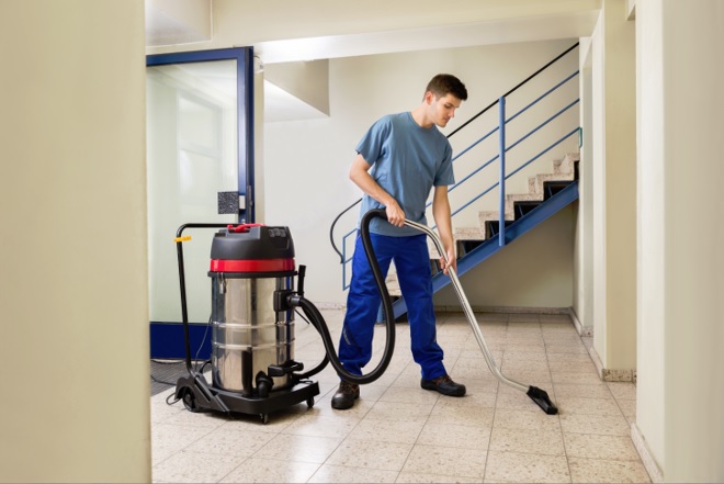 Man cleaning with vacuum cleaner