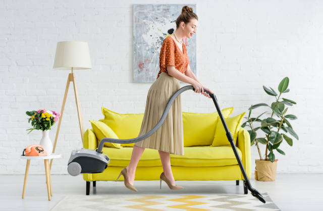 Woman Vacuuming Home and Carpet