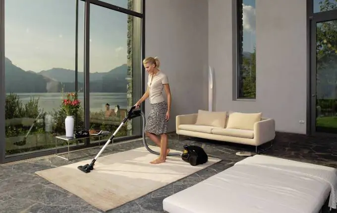 Woman vacuuming a house