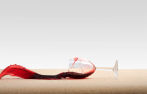 A photo of red wine being spilled onto carpet